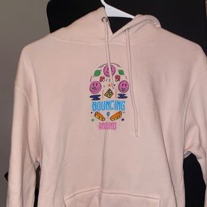 sweatshirt from zumies. light pink in color with graphics on the front and back